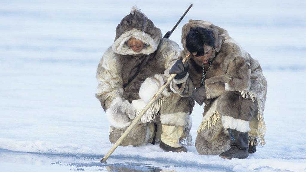 Inuit men hunting in traditional dress, Nunavut, Canada