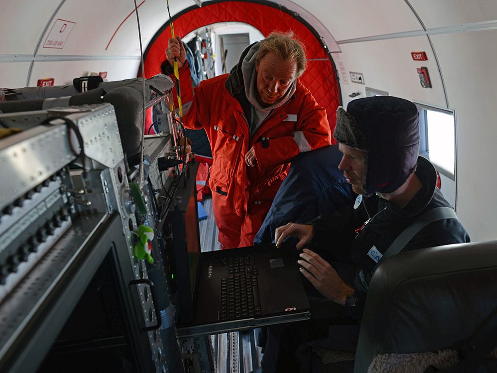 Christian Müller and Tobais Binder checking instruments prior to takeoff. - © International Polar Foundation / Jos Van Hemelrijck