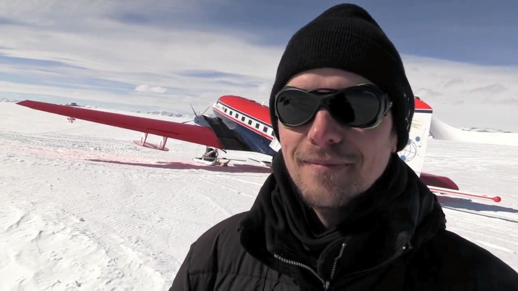 Graeme Eagles, AWI geophysicist, poses in front of AWI's Polar 6 aircraft - © International Polar Foundation / Jos Van Hemelrijck