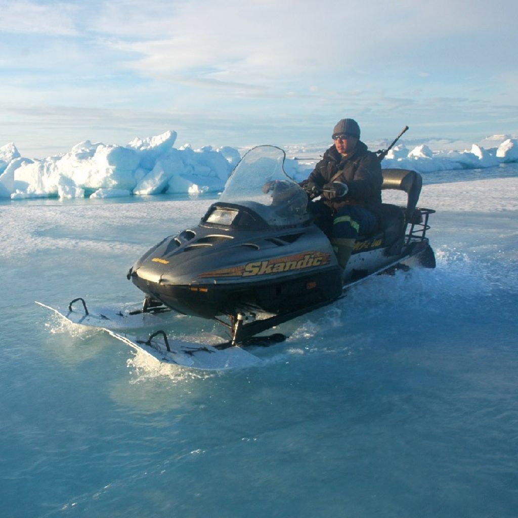 Inuit hunter travelling by skidoo on melting ice - © RÉMY MARION