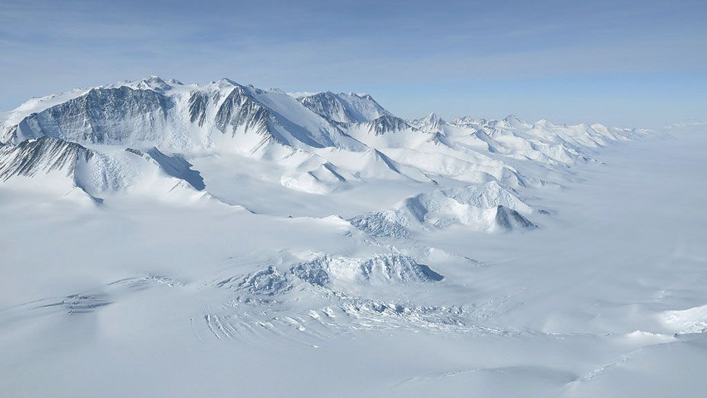 The Ellsworth Mountain Range peeks above the surface of the kilometres-thick ice sheet in Antarctica