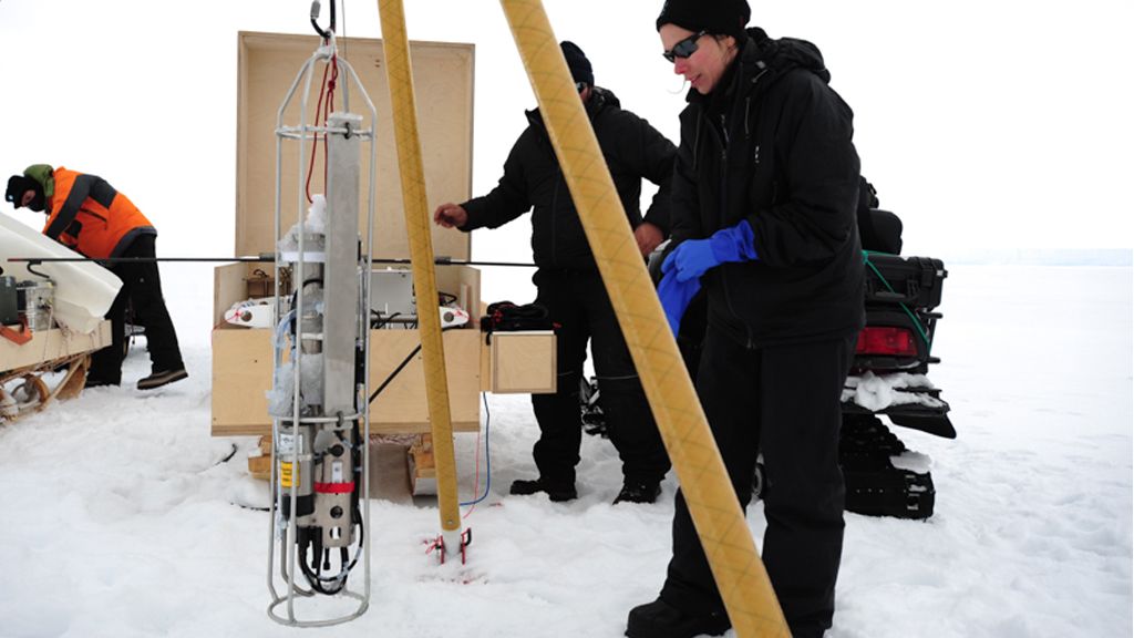 Katherine Leonard preparing to lower a CDT sensor beneath the ice shelf - © International Polar Foundation